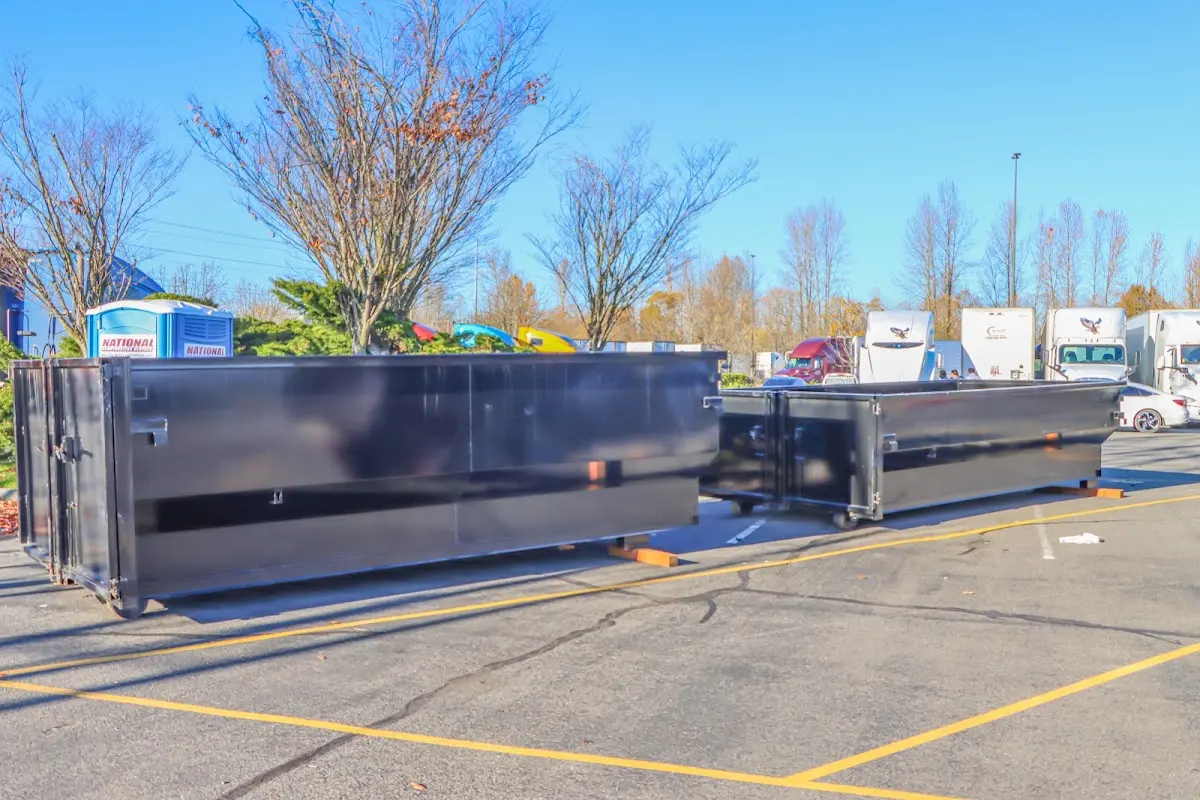 Professional dumpster rental service with roll-off container on residential driveway in Lincoln Park